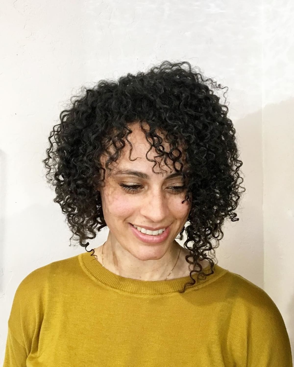 Asymmetrical curly bob with bangs