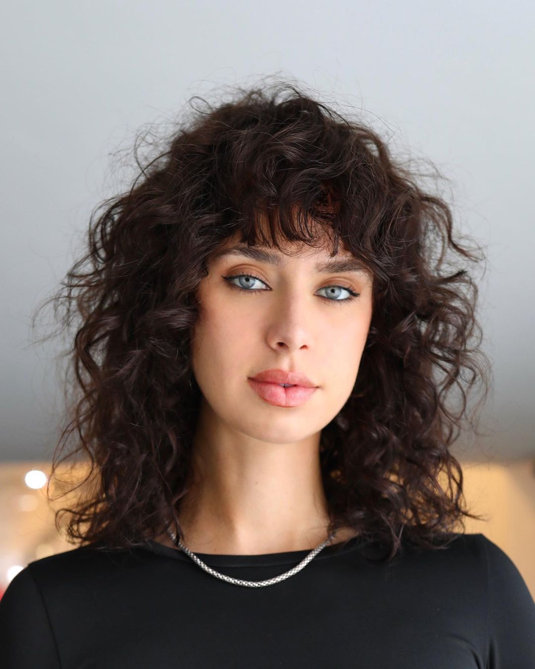 Shoulder Length Layered Curly Hair with Curly Bangs