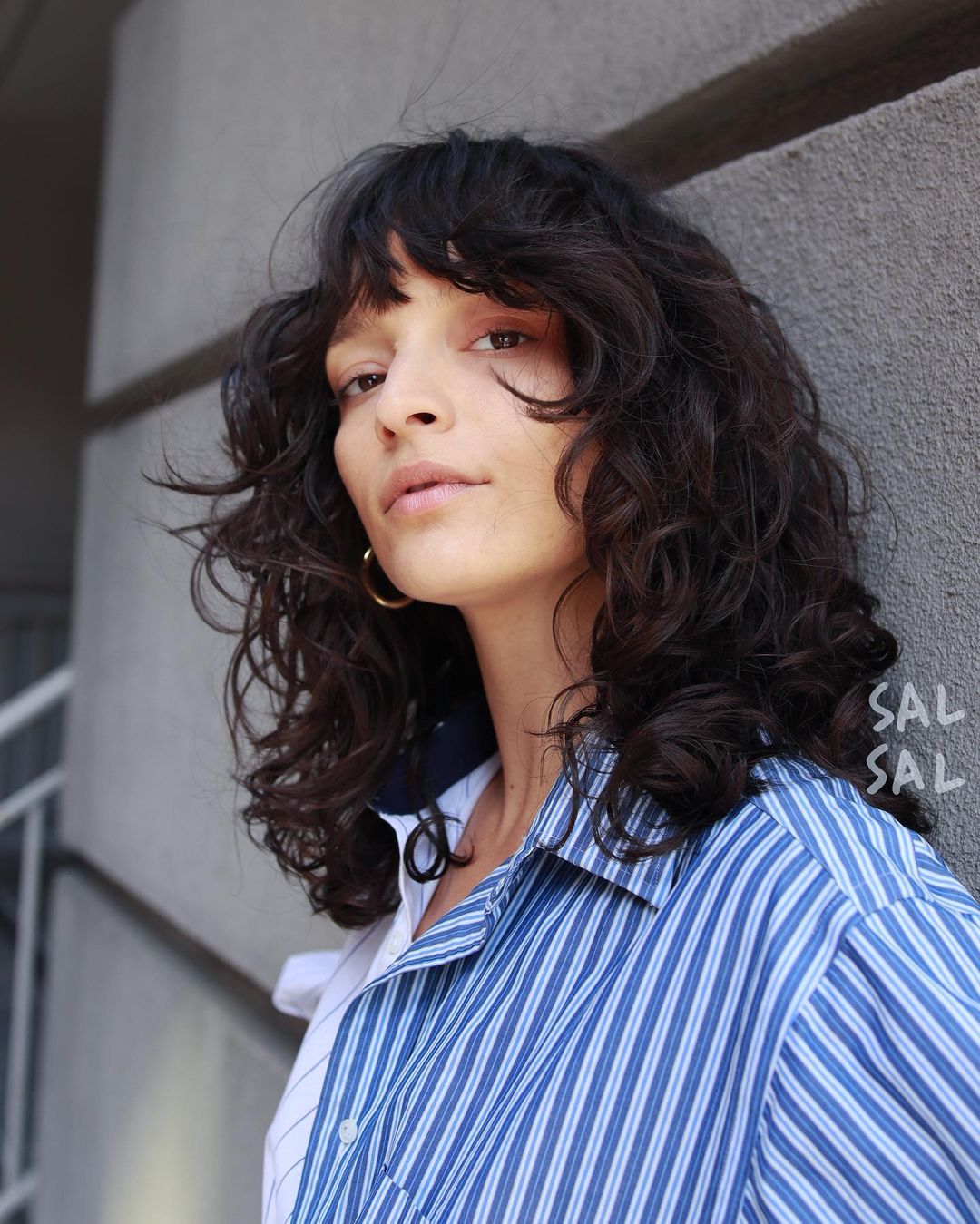 Shoulder Length Layered Curly Cut with Bangs