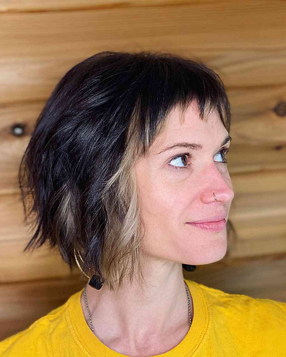 Chin-Length Textured Bob Cut with Baby Bangs and Face-Framing Highlights