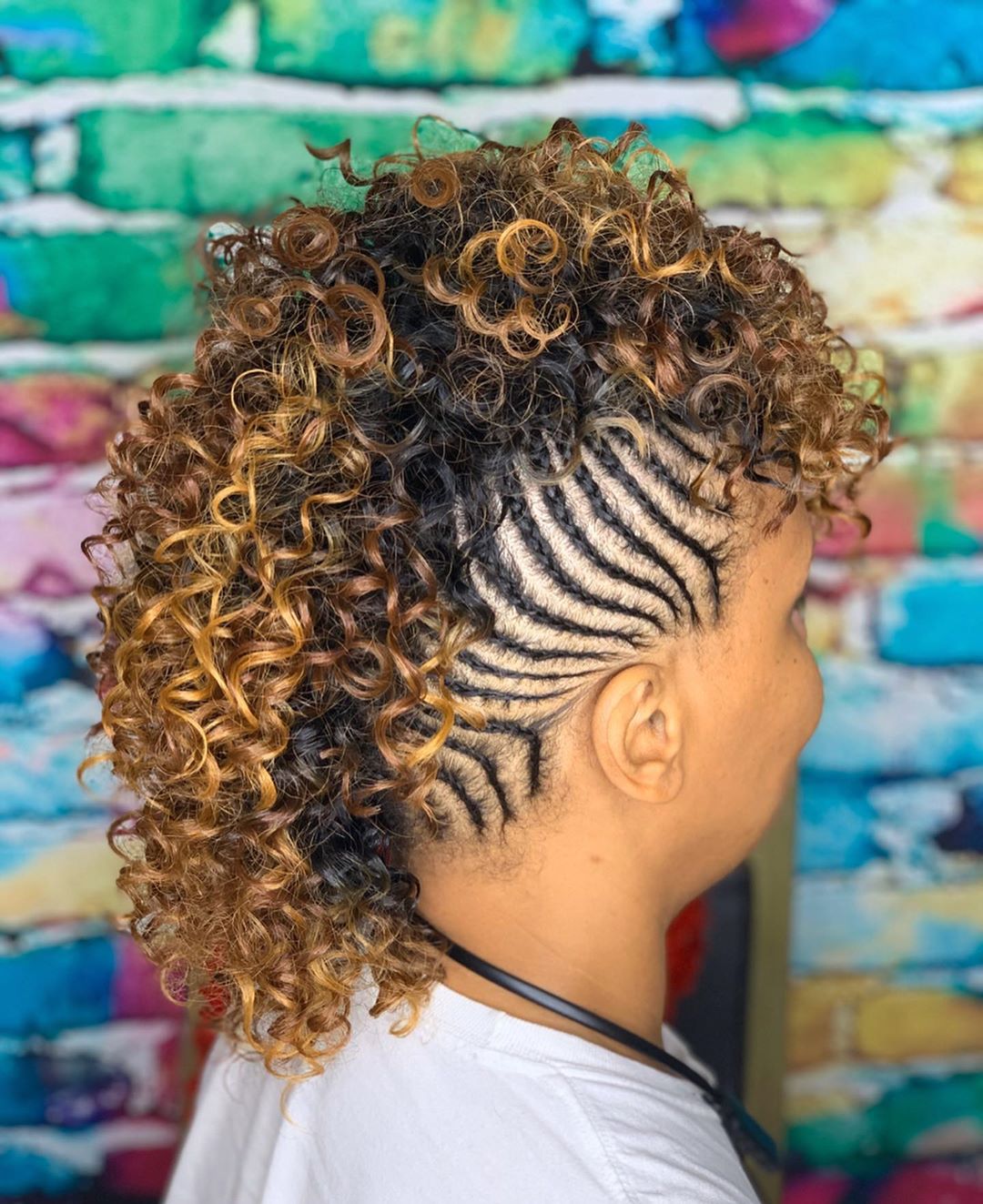 black woman's mohawk with side braids