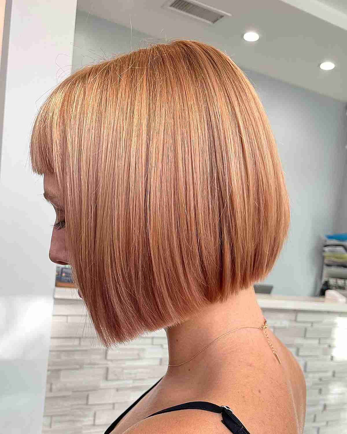 Micro Fringe on Short Neck-Length Strawberry Blonde Blunt Bob Hair