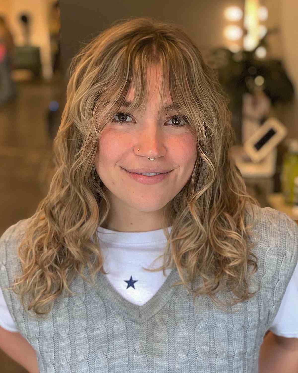 See-Through Curtain Bangs and Wavy Blonde Balayage Hair