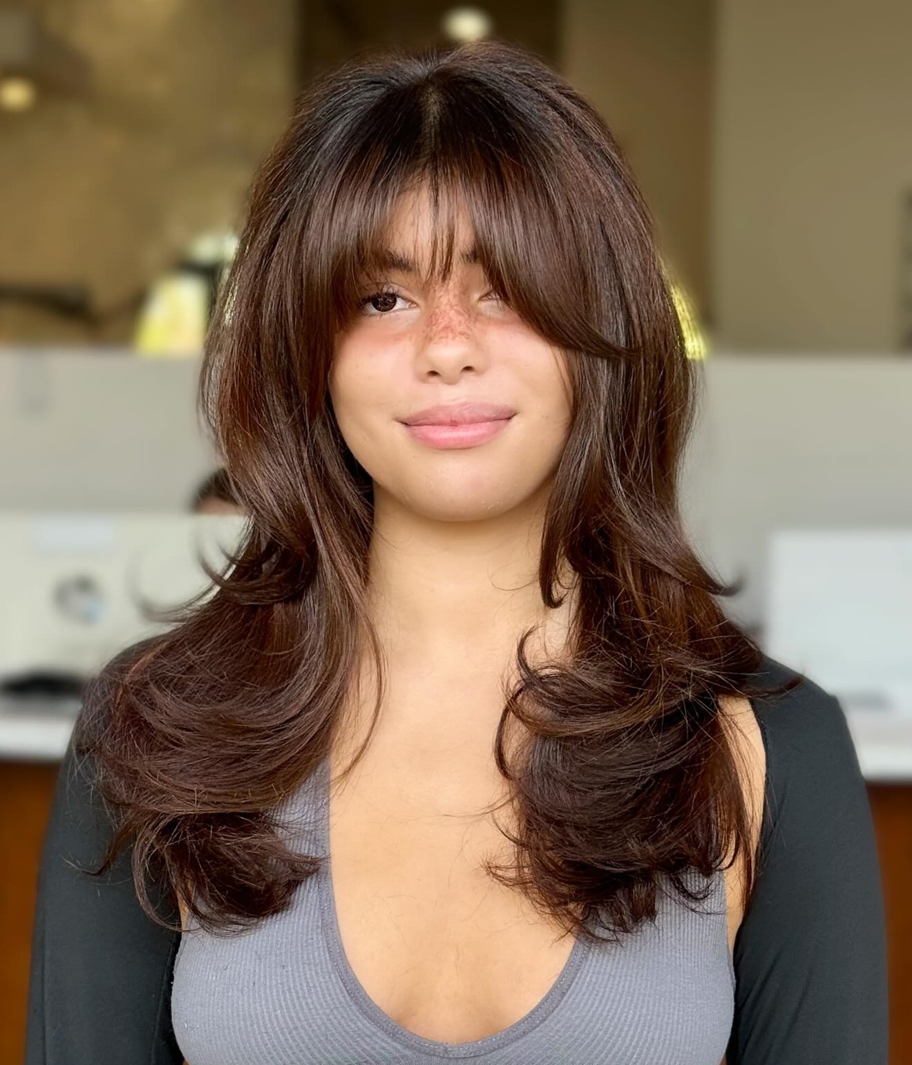 Haircut for a Round Face with Bangs and Layers