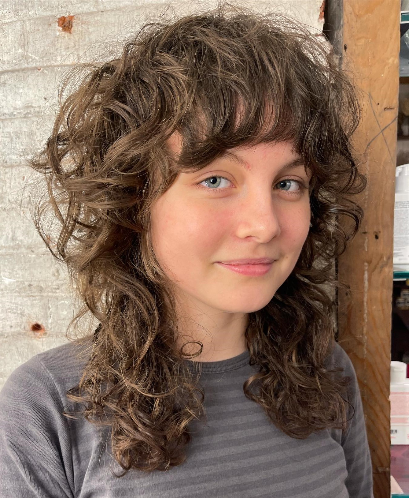 Curly Shag with Bangs for Round Faces