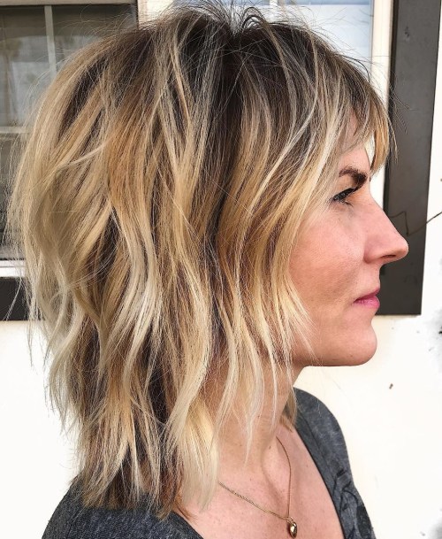 Medium Shag With Bangs And Blonde Highlights