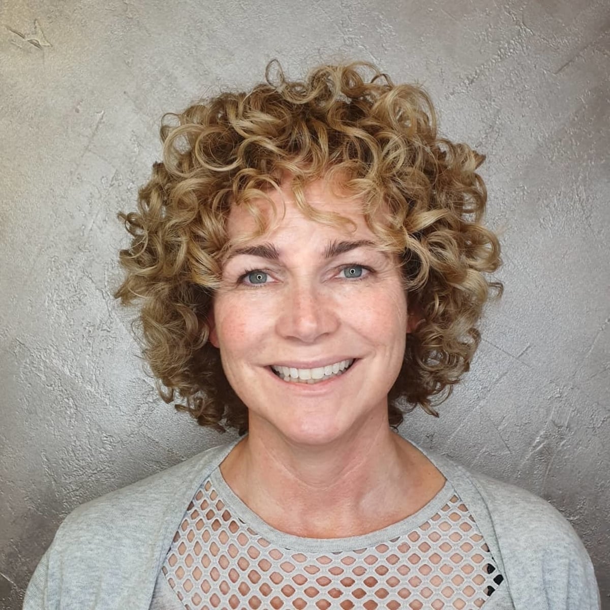 Short curly hairstyle on 50-year-old women