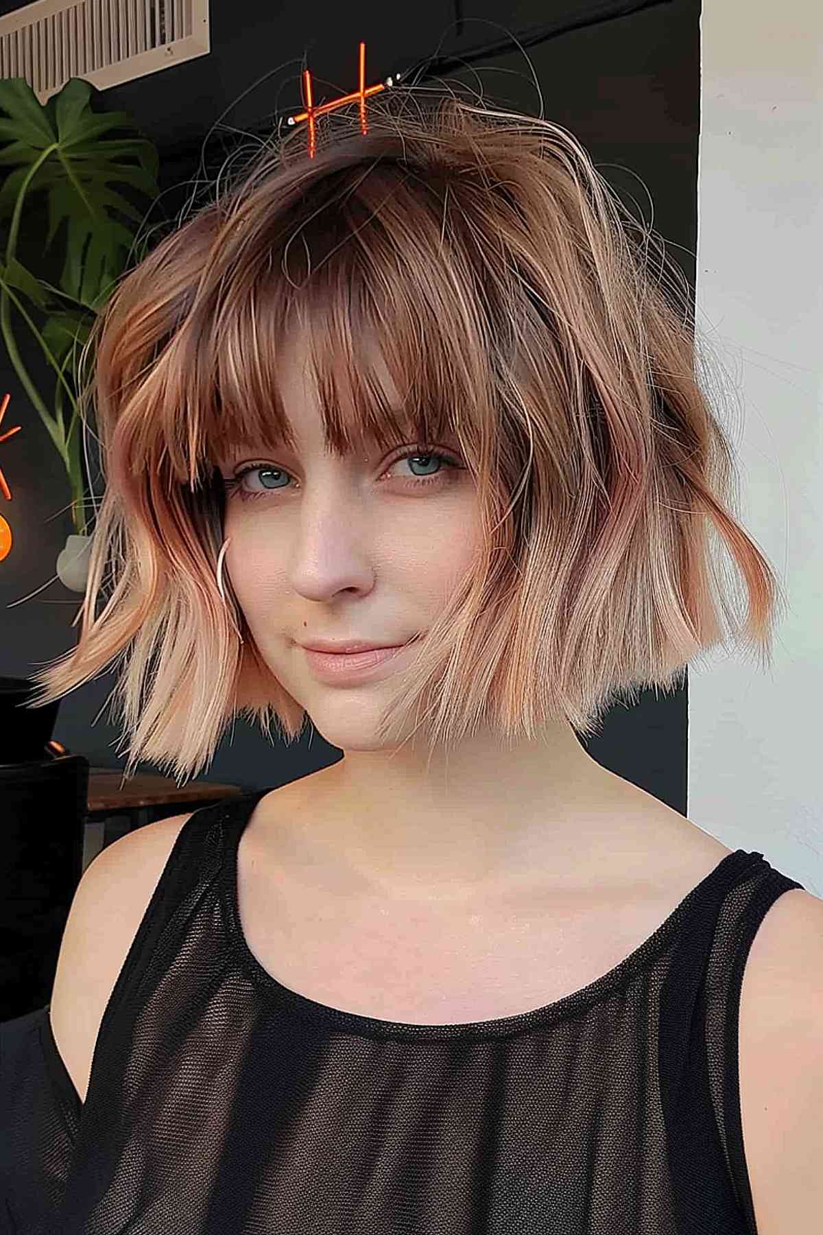 Shorter haircuts with bangs on chin-length wavy bob with playful hairpins