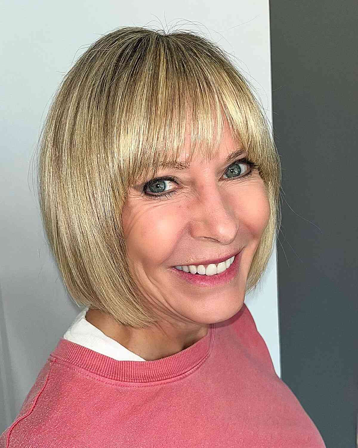 Chin-Length Fresh Bob Cut with Blonde Highlights for women over 50 with straight blonde hair