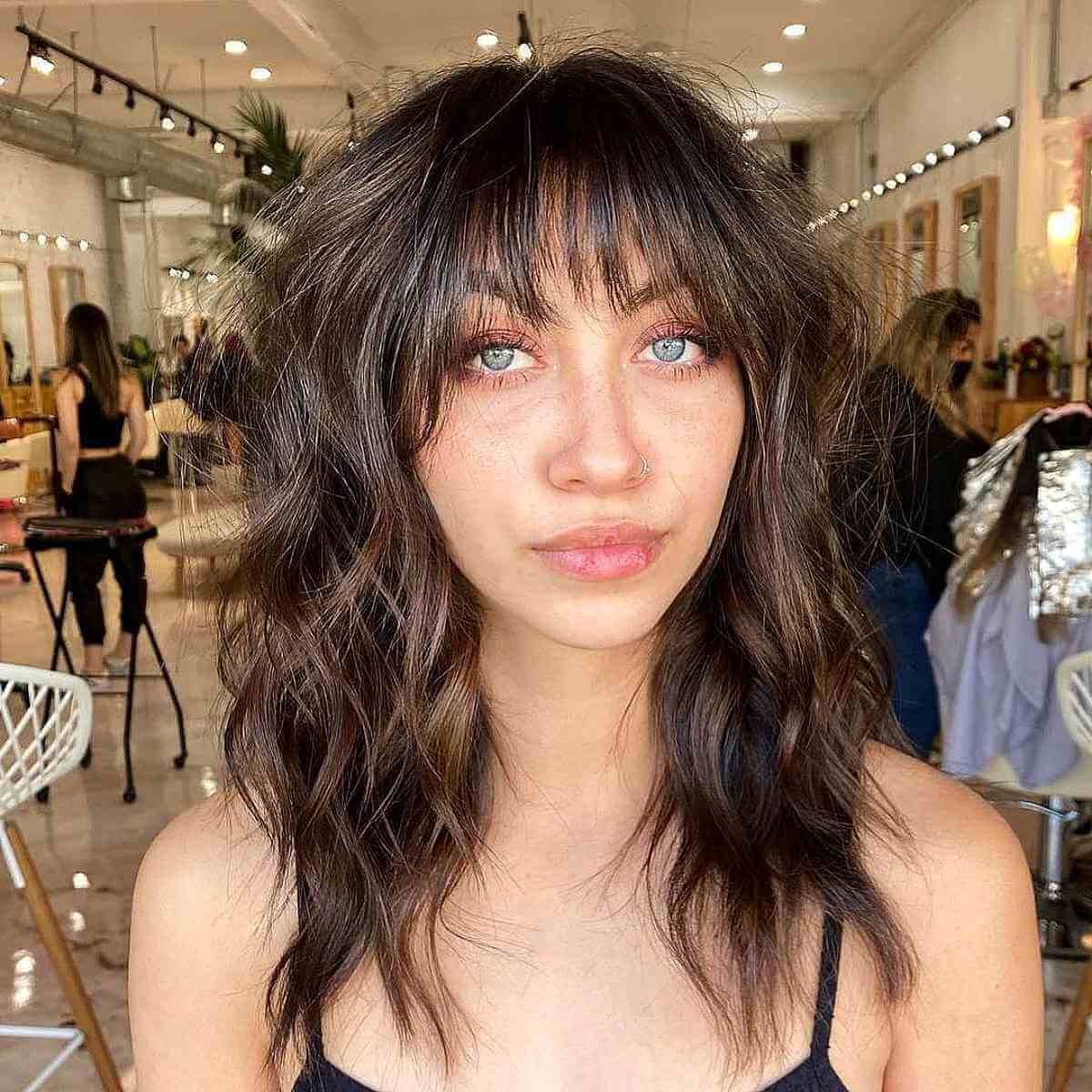 Medium Wavy Hair with Long Layers and Bangs