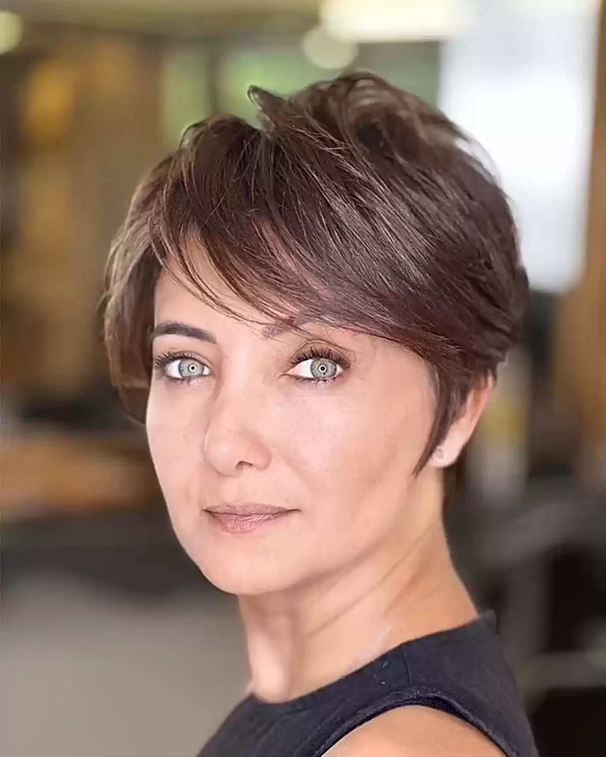 Sweeping Brunette Long Pixie Cut for Ladies Aged 40