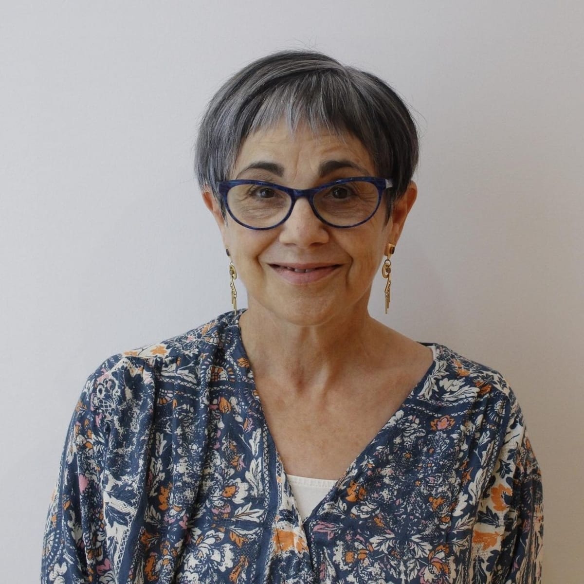 Asymmetrical pixie hairstyle with eyeglasses on older women