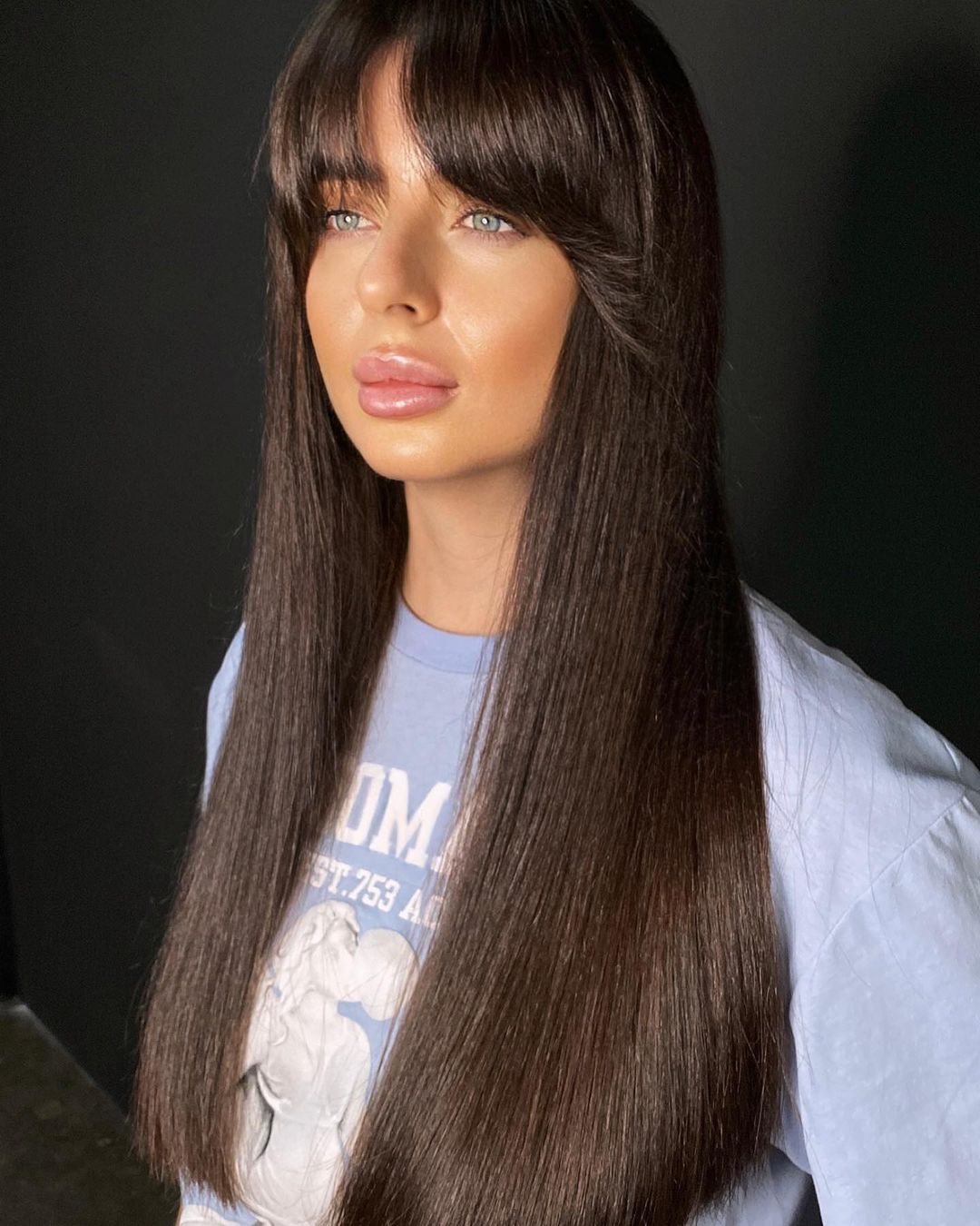 Sleek Chocolate Brown Hair with Curtain Bangs