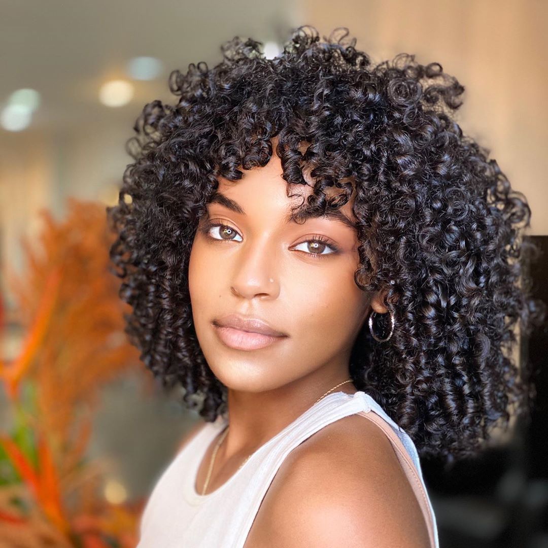 voluminous curly long bob with curly bangs