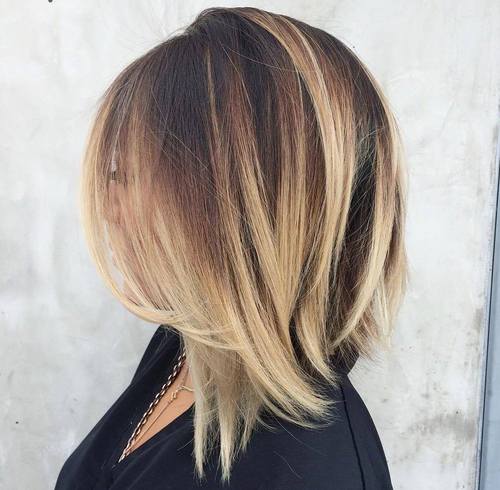 angled dark brown lob with blonde balayage