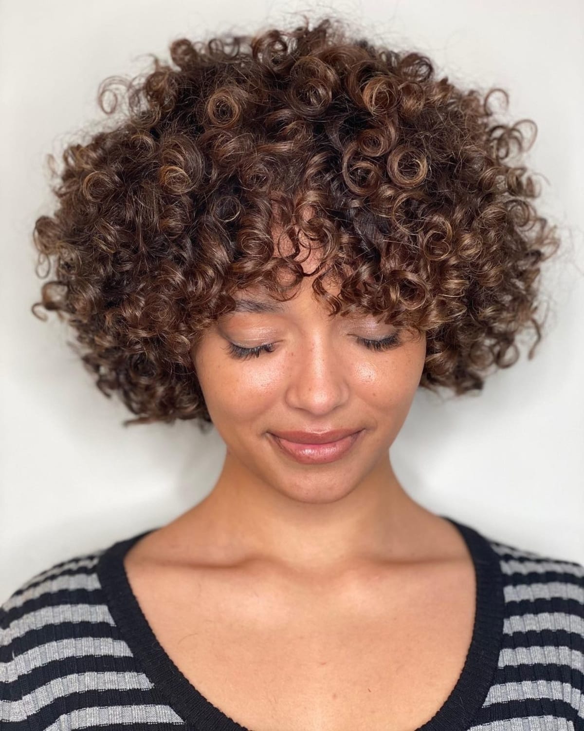 Choppy curly bob with blunt bangs