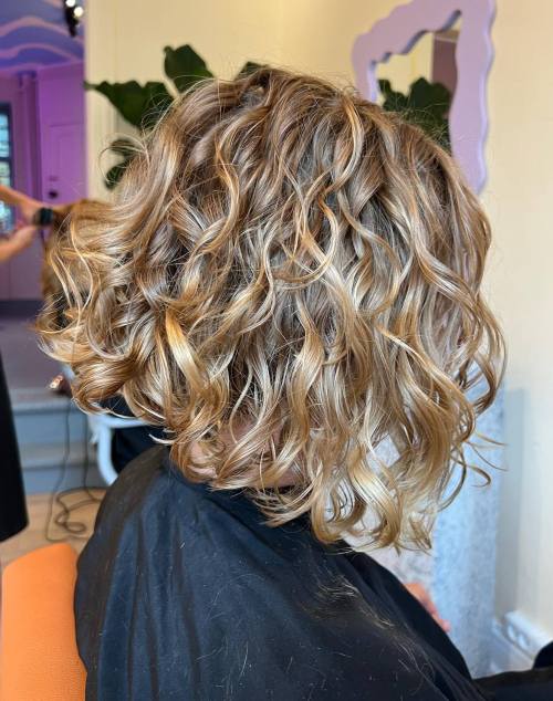 Inverted Curly Bob with Golden Highlights