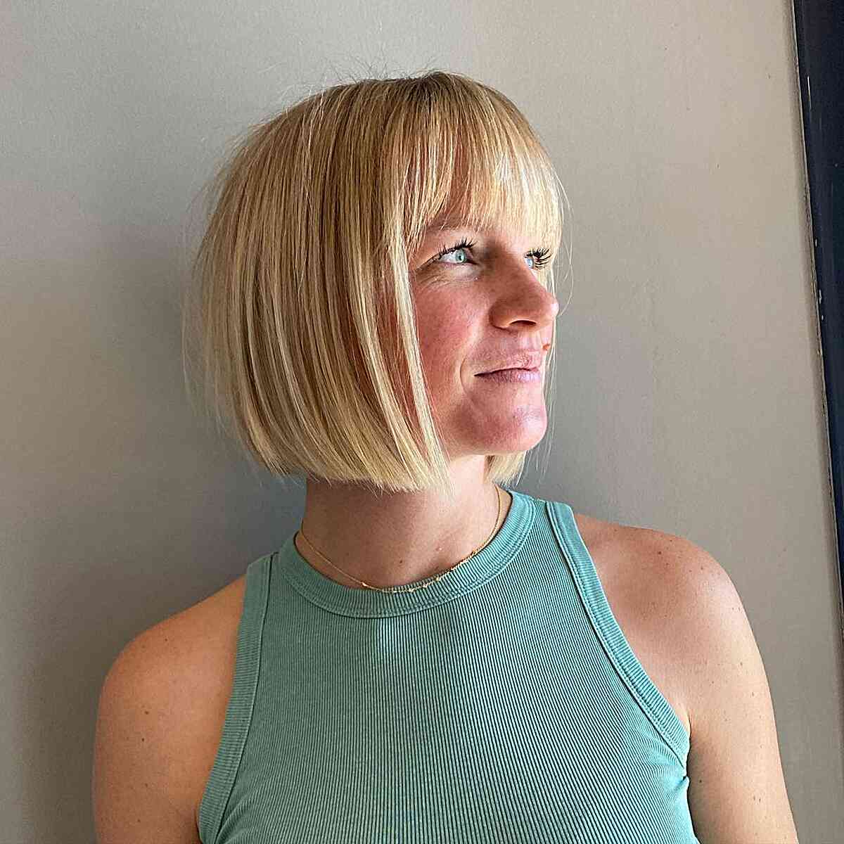 Short Blunt Blonde Bob with Thin, Full Bangs and Slight Graduation